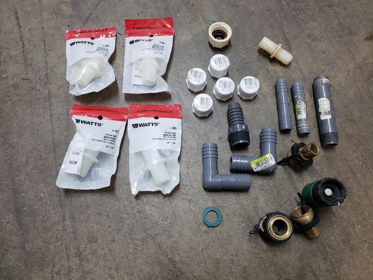 A bunch of miscellanous outdoor piping fittings and caps
