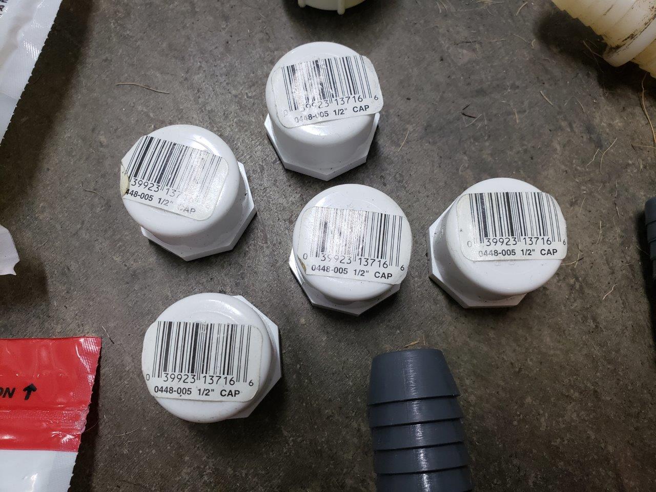 A bunch of miscellanous outdoor piping fittings and caps